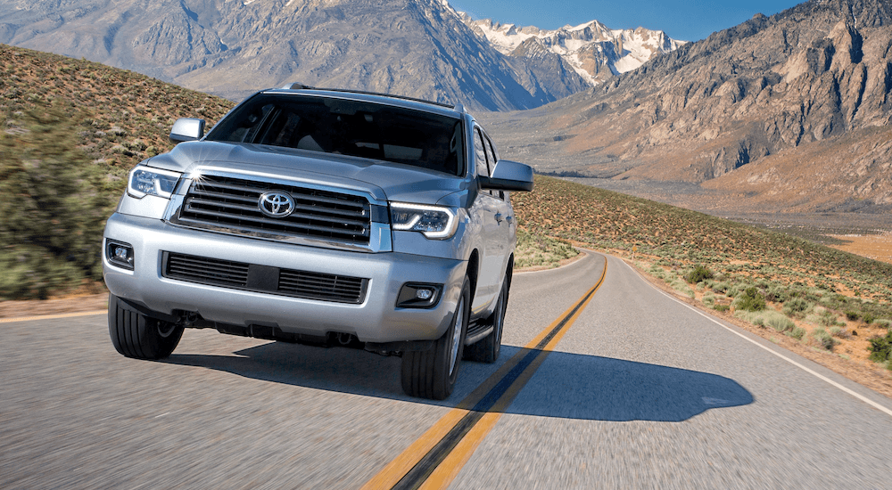 Silver 2019 Toyota Sequoia driving towards camera with mountains in back