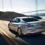 A silver Toyota Camry on a bridge