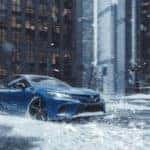 2020 toyota camry awd blue exterior driving in snow