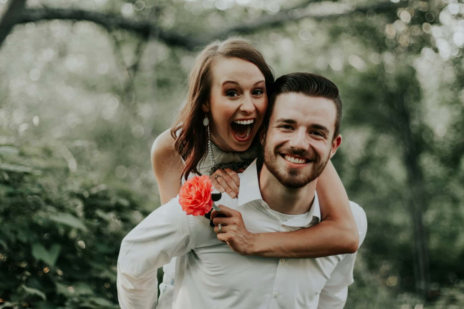 Woman smiling on man's back