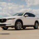 A white mazda cx - 5 parked in a parking lot