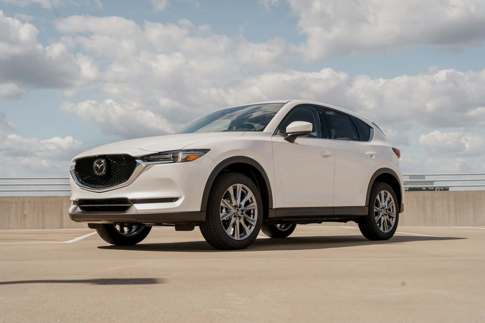 A white mazda cx - 5 parked in a parking lot
