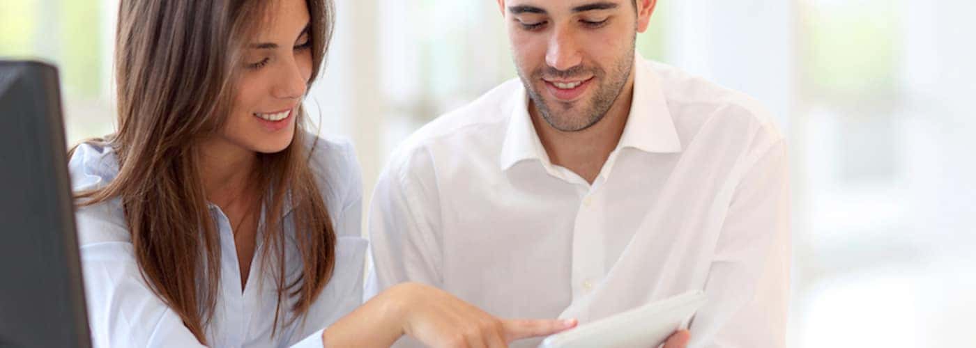 couple at home looking at touchpad together