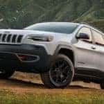 Image of a white 2019 Jeep Cherokee driving up a steep mountain road.
