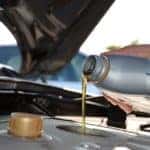 Image of motor oil being poured into an engine.