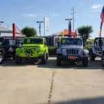 Image of four Jeep SUVs parked in a dealer's lot.