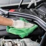 Image of a mechanic cleaning off a car engine.