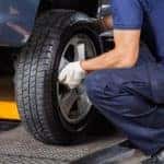 Image of a mechanic replacing a tire.