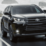 2019 Highlander driving near a shore