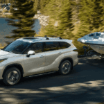 2020 Toyota Highlander towing a boat on Dallas road