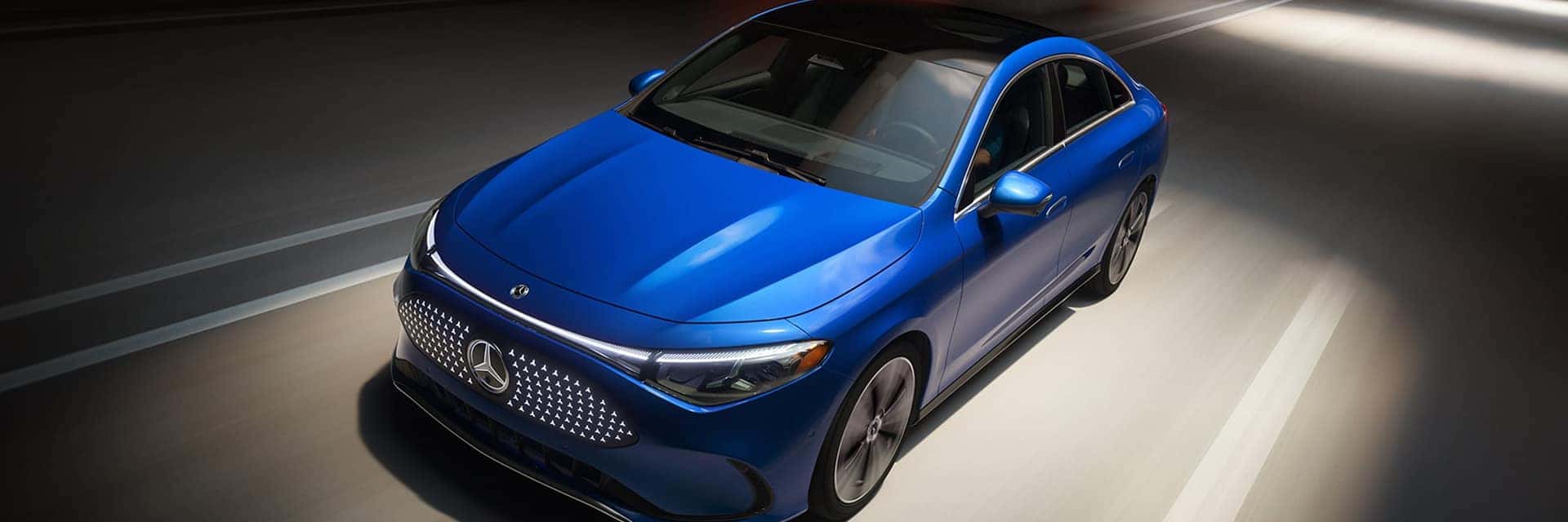 blue cla sedan driving