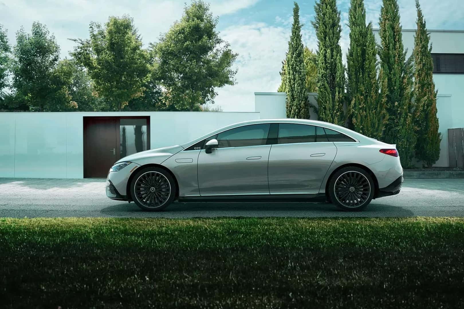 mercedes benz eqe sedan parked in front of home