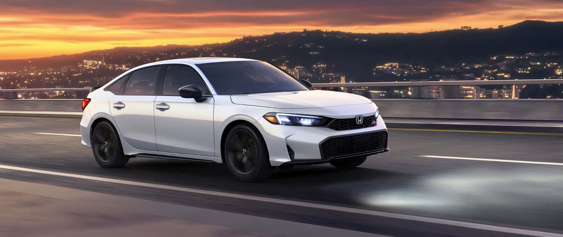 A silver Honda Civic Is driving over a bridge outside a city.