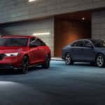 Two 2026 Honda Accord sedans, one red and one gray, parked outside a building