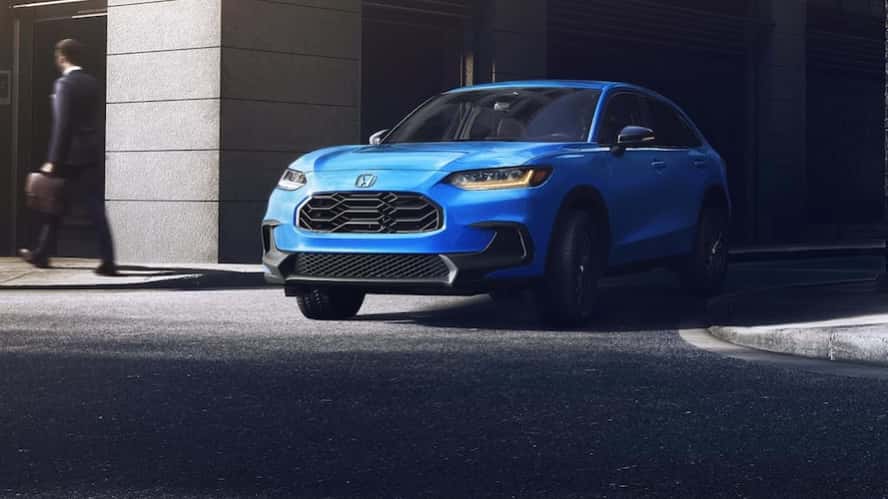 A blue 2026 Honda HR-V SUV turning onto a city street