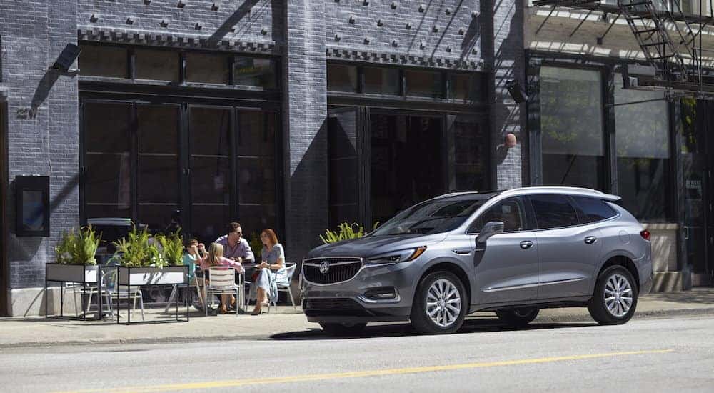 The stylish 2019 Buick Enclave in silver parked outside a small cafe