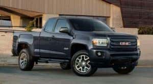 A black 2019 GMC Canyon is parked outside a building near Atlanta, GA.