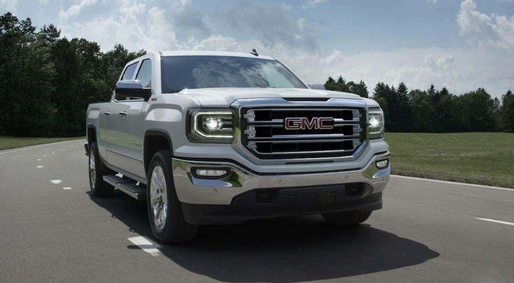 A white 2017 GMC Sierra is driving on a highway outside Atlanta, GA.