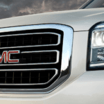 The front end of a white 2019 GMC Yukon is shown.