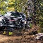A black 2019 GMC Sierra 1500 AT4 is on a trail after leaving a GMC dealer near me.