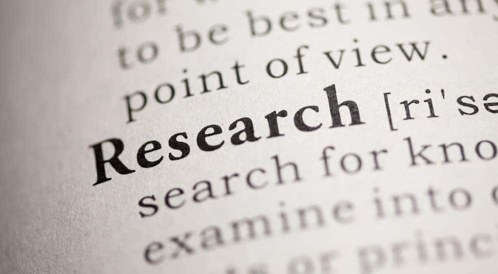 The word 'Research' is shown in a dictionary to show you to research 'Used Car Dealership Near Me'.