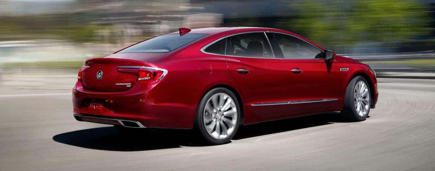 A red 2019 Buick Lacrosse is driving with a blurred background.