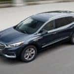 A 2019 Buick Enclave Avenir is driving with a blurred background after leaving a Buick dealer in Atlanta.