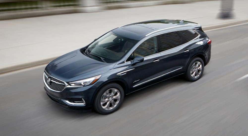 A 2019 Buick Enclave Avenir is driving with a blurred background after leaving a Buick dealer in Atlanta.