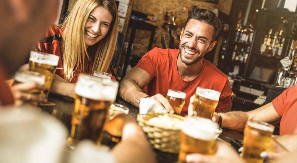 Friends are enjoying drinks and food at a local Atlanta, GA pub.