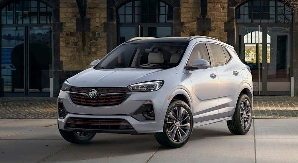 A silver 2020 Buick Encore GX is parked in front of a brick building near Atlanta, GA.