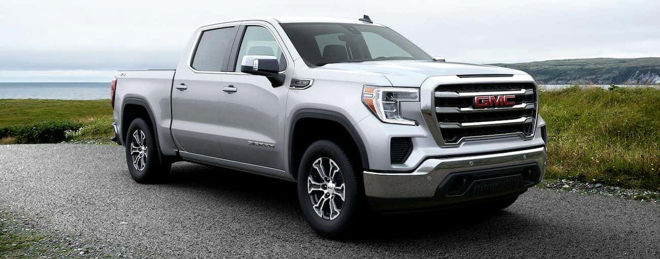 A silver 2020 GMC Sierra 1500 SLE is shown with wheel upgrades.