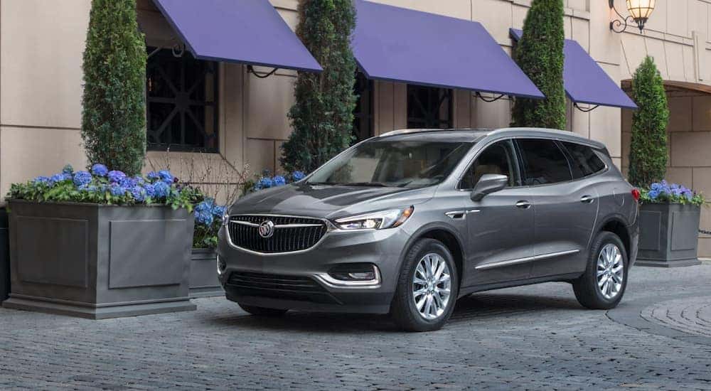 A grey 2020 Buick Enclave is parked in front of a small store near Atlanta, GA.