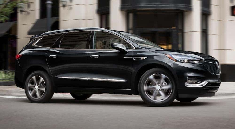 A black 2020 Buick Enclave, which is a popular option among the Buick SUVs, is driving on a city street near Atlanta, GA.