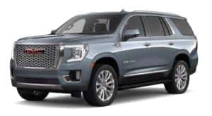 A light blue 2021 GMC Yukon is facing left.