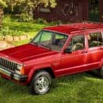 A red 1984 Jeep Cherokee is parked in front of cabin outside of Atlanta, GA.