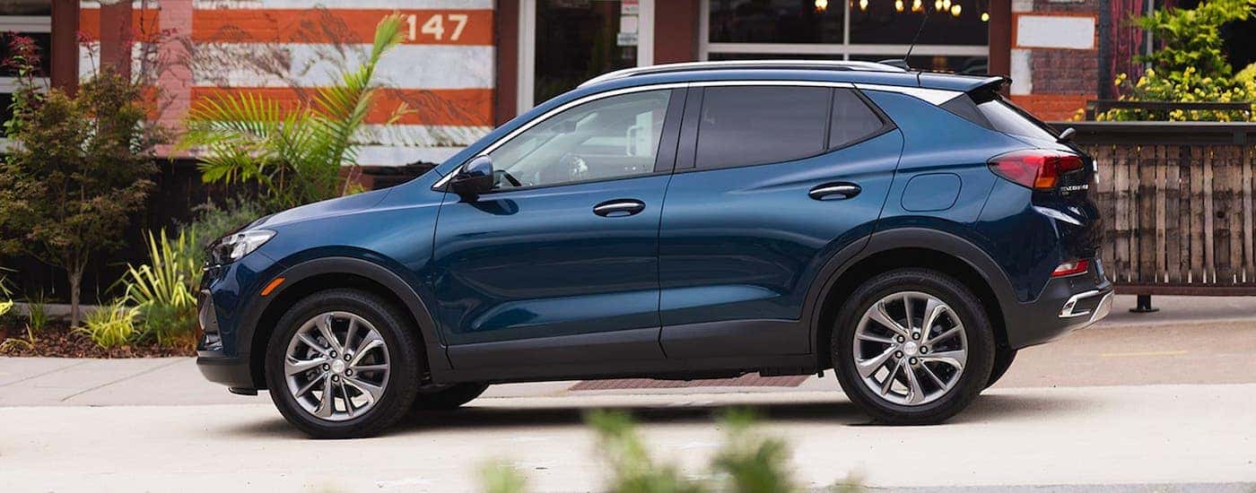 A dark blue 2020 Buick Encore GX is parked in front of an Atlanta building after winning the 2020 Buick Encore GX vs 2021 Chevy Trailblazer comparison.