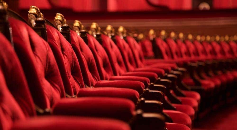 Red theater seating is shown.