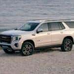 A white 2021 GMC Yukon AT4 is parked in front of beach near Atlanta, GA.