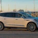 A white 2019 Buick Enclave Premium from the best used car dealership in the Atlanta area is parked at a marina.