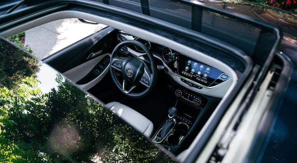 The interior of a 2020 Buick Encore GX is shown from above through the open sunroof.