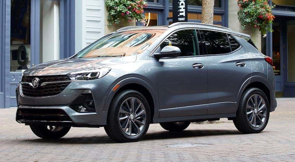 A grey 2020 Buick Encore GX ST, one of the new Buick SUVs, is parked on a cobblestone street.