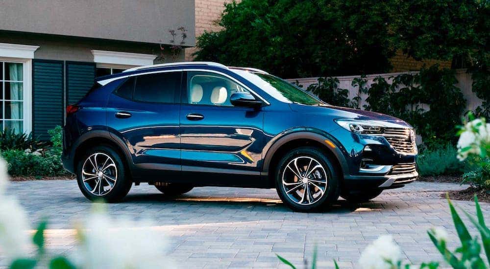 A dark blue 2021 Buick Encore GX is parked in a driveway after leaving an Atlanta Buick dealer.