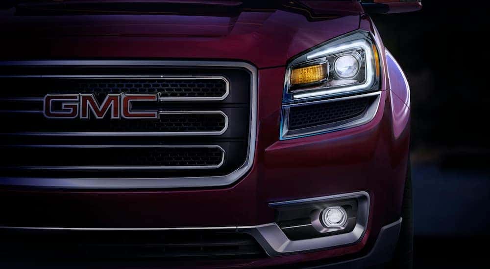 A close up shows the headlight on a 2014 GMC Acadia.
