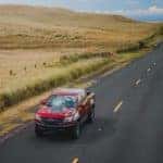 A red 2020 Chevy Colorado ZR2 is shown driving down the road after leaving an Atlanta pre-owned Chevy dealer.