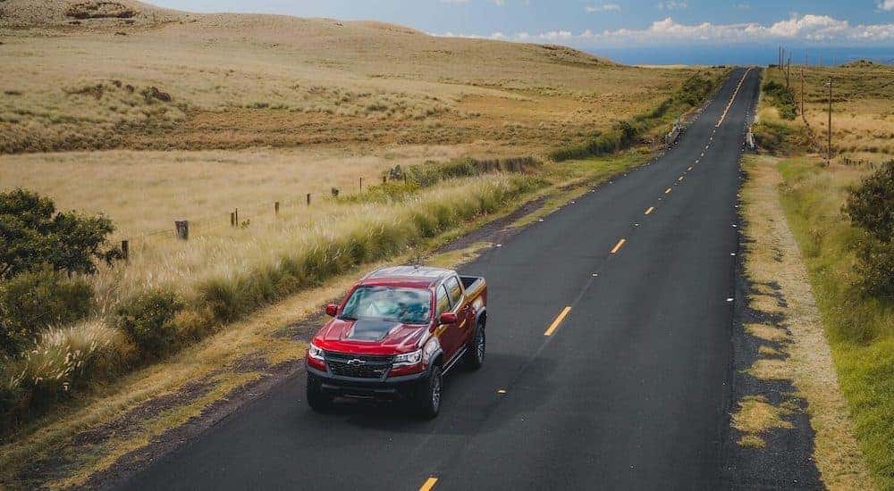 A red 2020 Chevy Colorado ZR2 is shown driving down the road after leaving an Atlanta pre-owned Chevy dealer.
