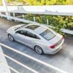 A silver 2017 Buick LaCrosse is shown from a high angle driving over a bridge after leaving an Atlanta used car dealer.