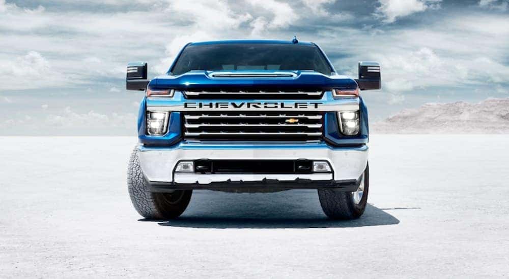 A blue 2020 Chevy Silverado 1500 HD is shown from the front parked on the salt flats after looking at used trucks in Atlanta.