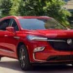 A red 2022 Buick Enclave is shown leaving a Buick dealership in Duluth, GA.