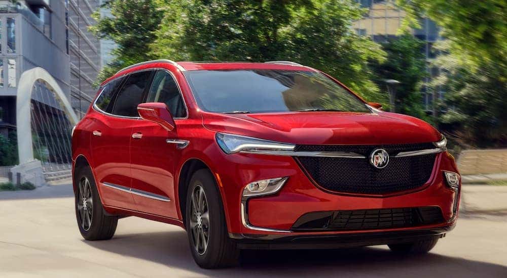 A red 2022 Buick Enclave is shown leaving a Buick dealership in Duluth, GA.