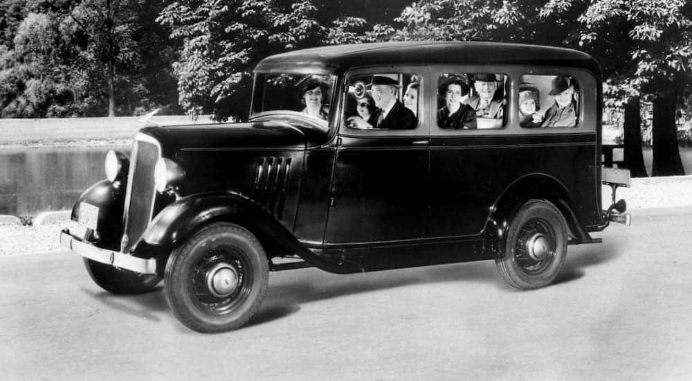 A family driving a 1935 Chevy Suburban is shown in black and white.